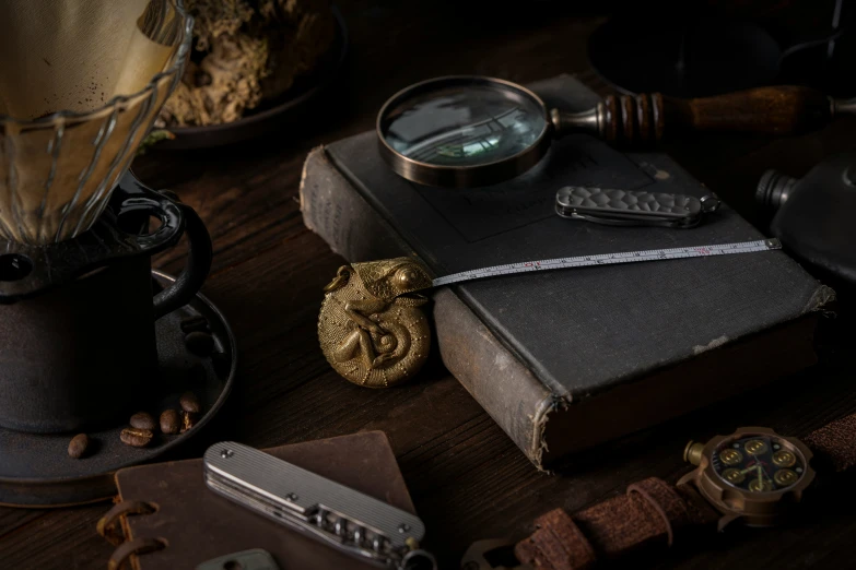 several antiques with a magnifying glass sitting on a table