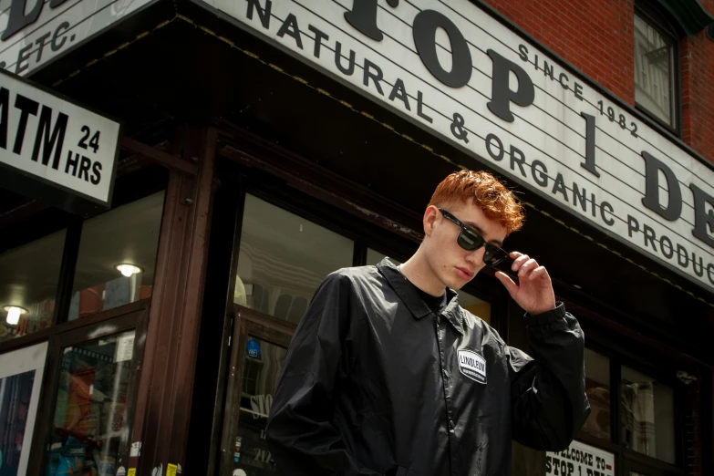 a man with red hair is talking on a phone