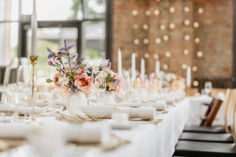 a long table with lots of white dishes on top of it