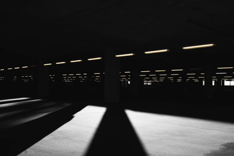 a dark room with long windows and floor