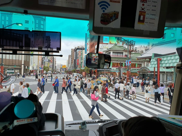 people crossing in the street at a cross walk