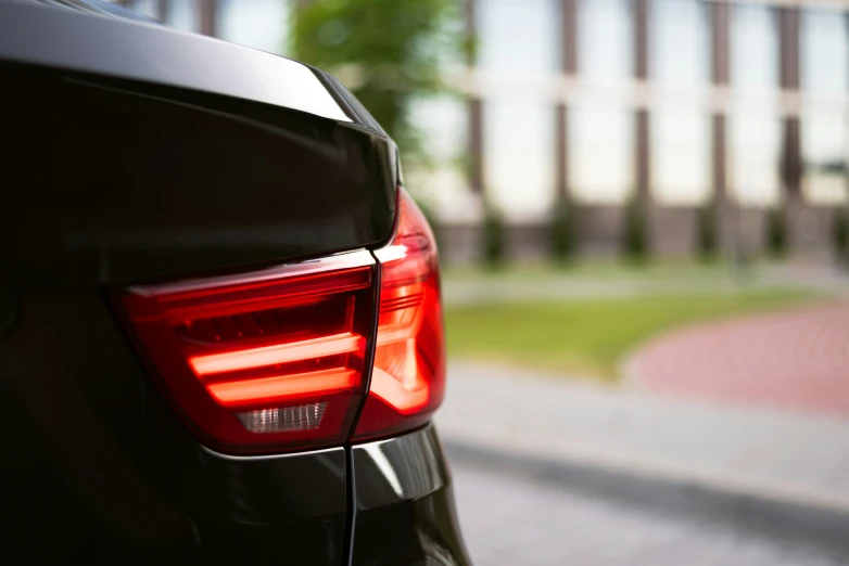 back lights on a modern, dark vehicle on an empty city street