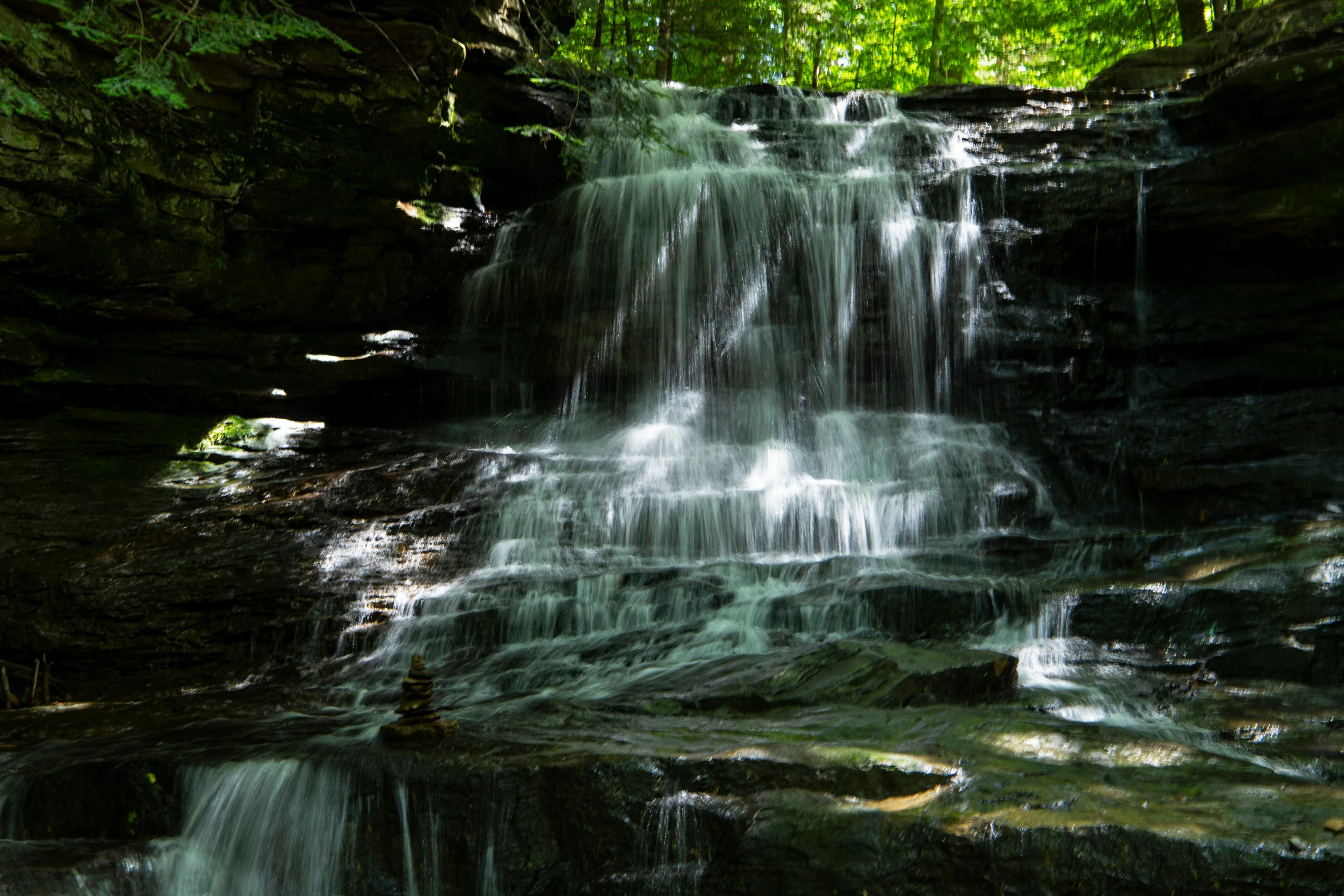 there is a waterfall that is surrounded by trees