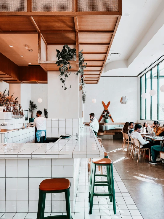 people sitting around at a counter in a restaurant