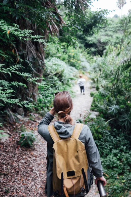 a person walking down a forest path with a backpack