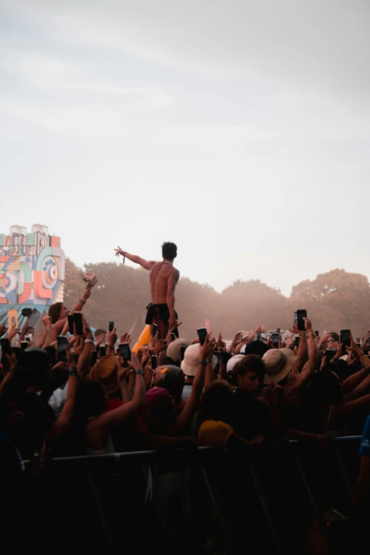 a man standing on top of a crowd of people