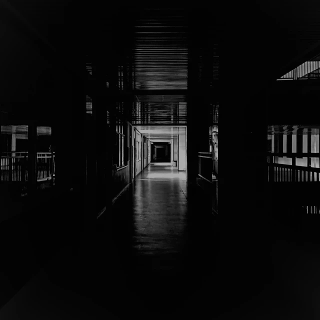 a long hallway between two buildings in the dark
