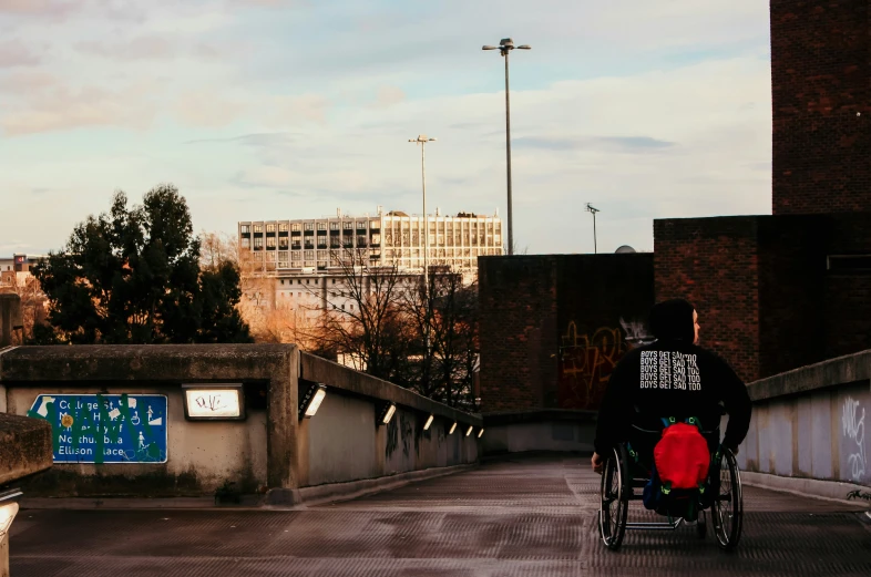 a person in a wheelchair riding on the bridge