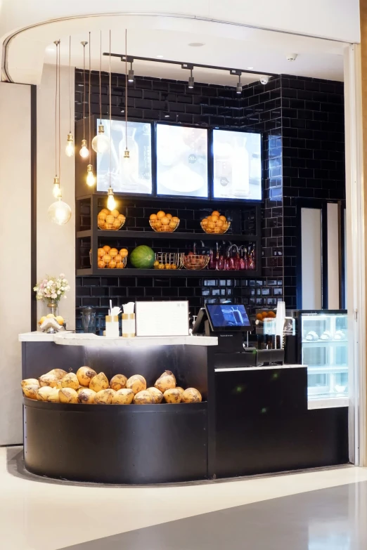 a counter inside a store with many pastries on display