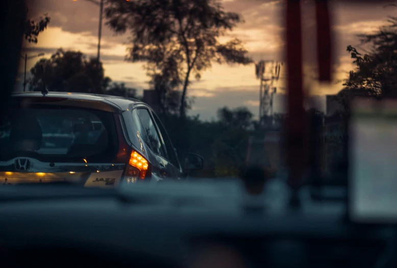 a small yellow and black car stopped at a traffic light