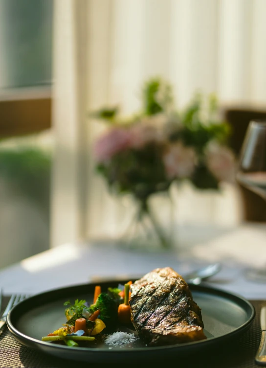 a piece of meat with vegetables on a plate