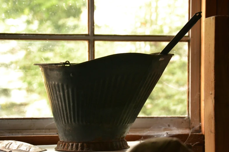 a wooden spoon and a large gray pot