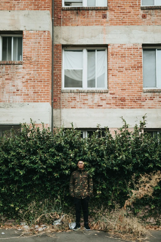 a man wearing an animal jacket in front of an apartment building