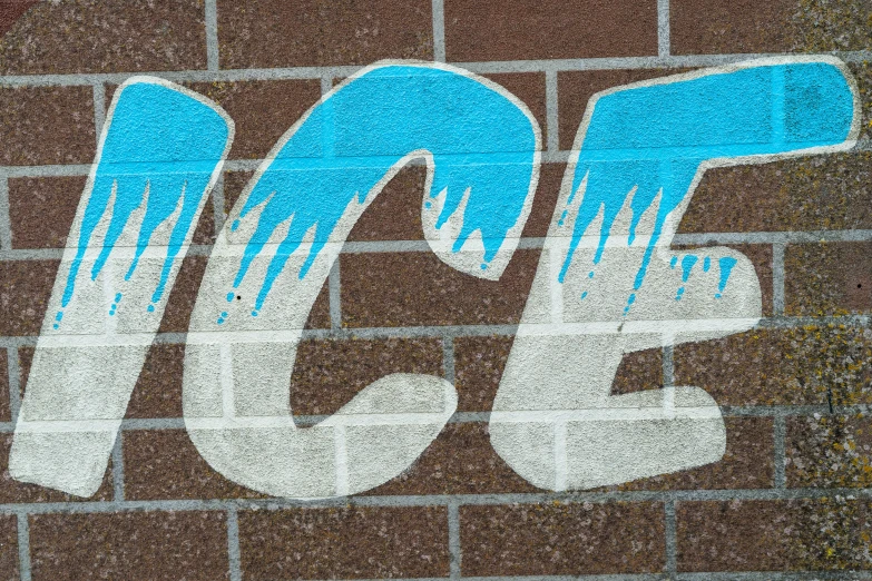 graffiti on the side of a brick building reads 350