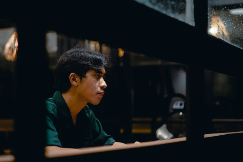 a man looks out at the sky from a window