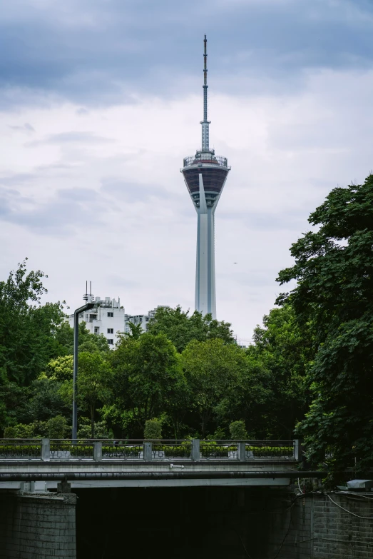 a bridge that crosses a river with a tower on top