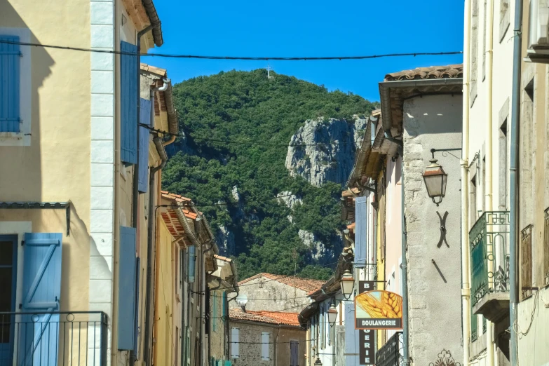 a hill rises behind the buildings near each other