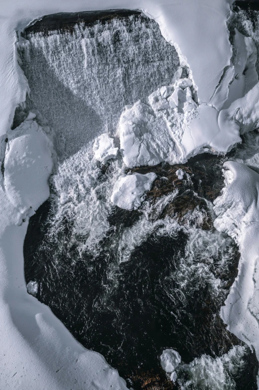 an aerial view of a pile of snow on a sidewalk