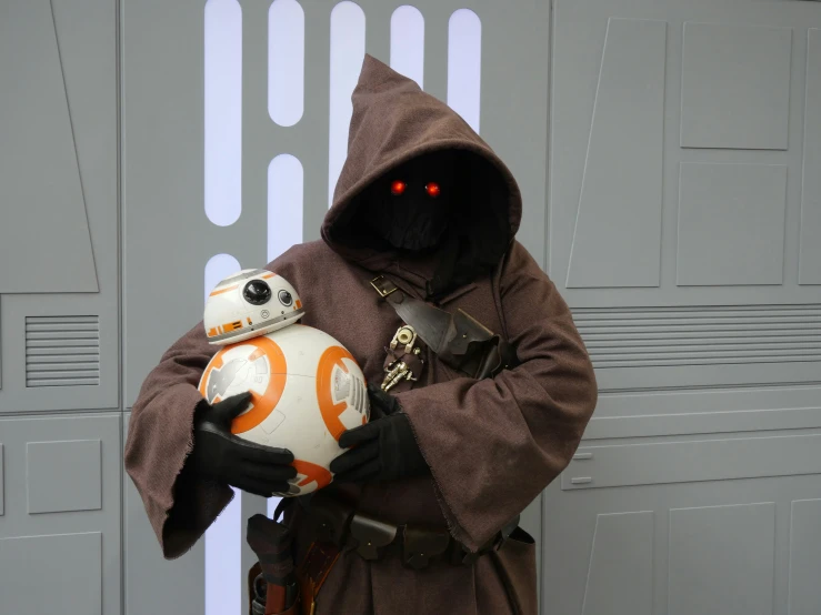 a person dressed as star wars character holding a ball