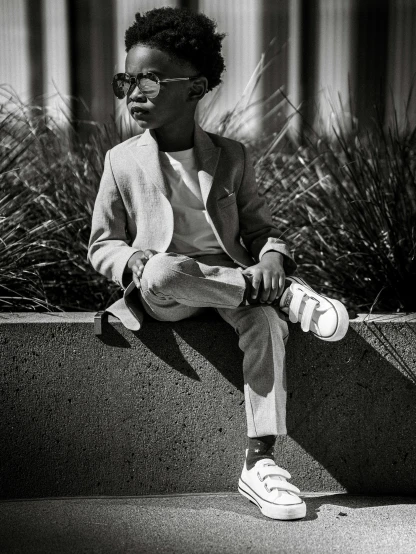 a young person sitting on top of a bench