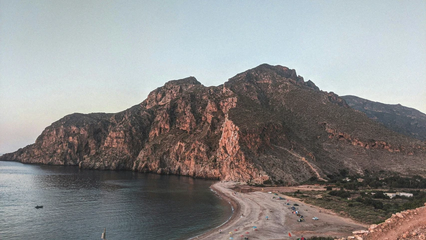 a rocky landscape overlooking the ocean and mountains