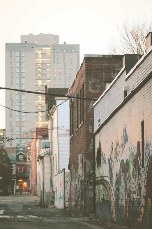 an alley with graffiti on the side