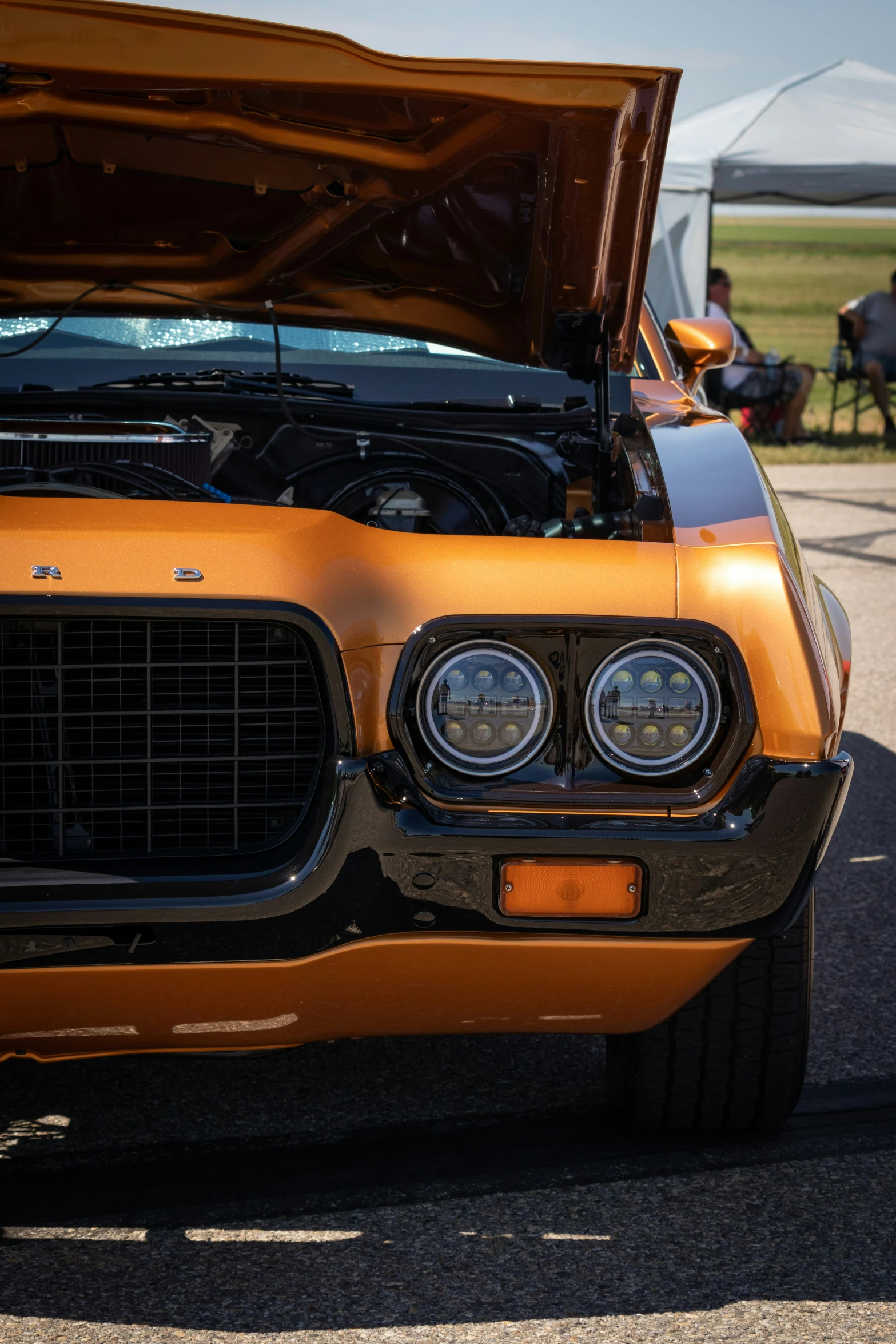 a yellow, clean looking car with hood open