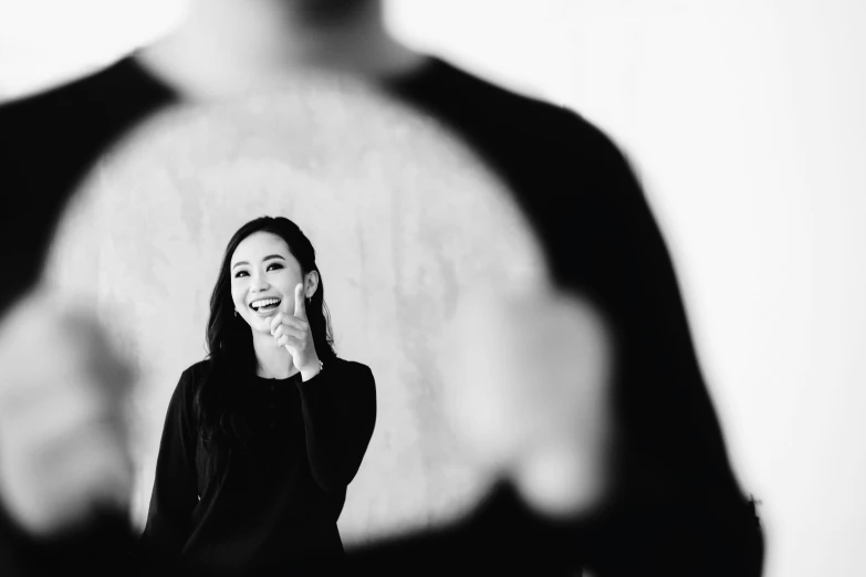 a woman looking through a mirror as she makes her face