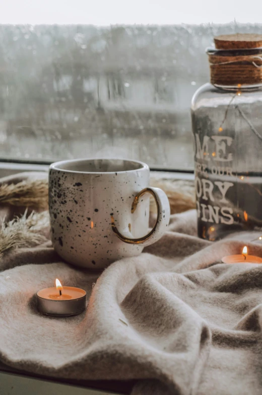 an old coffee cup has been used as a candle holder