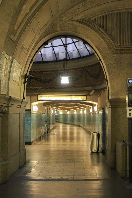 an arched tunnel with lights at one end