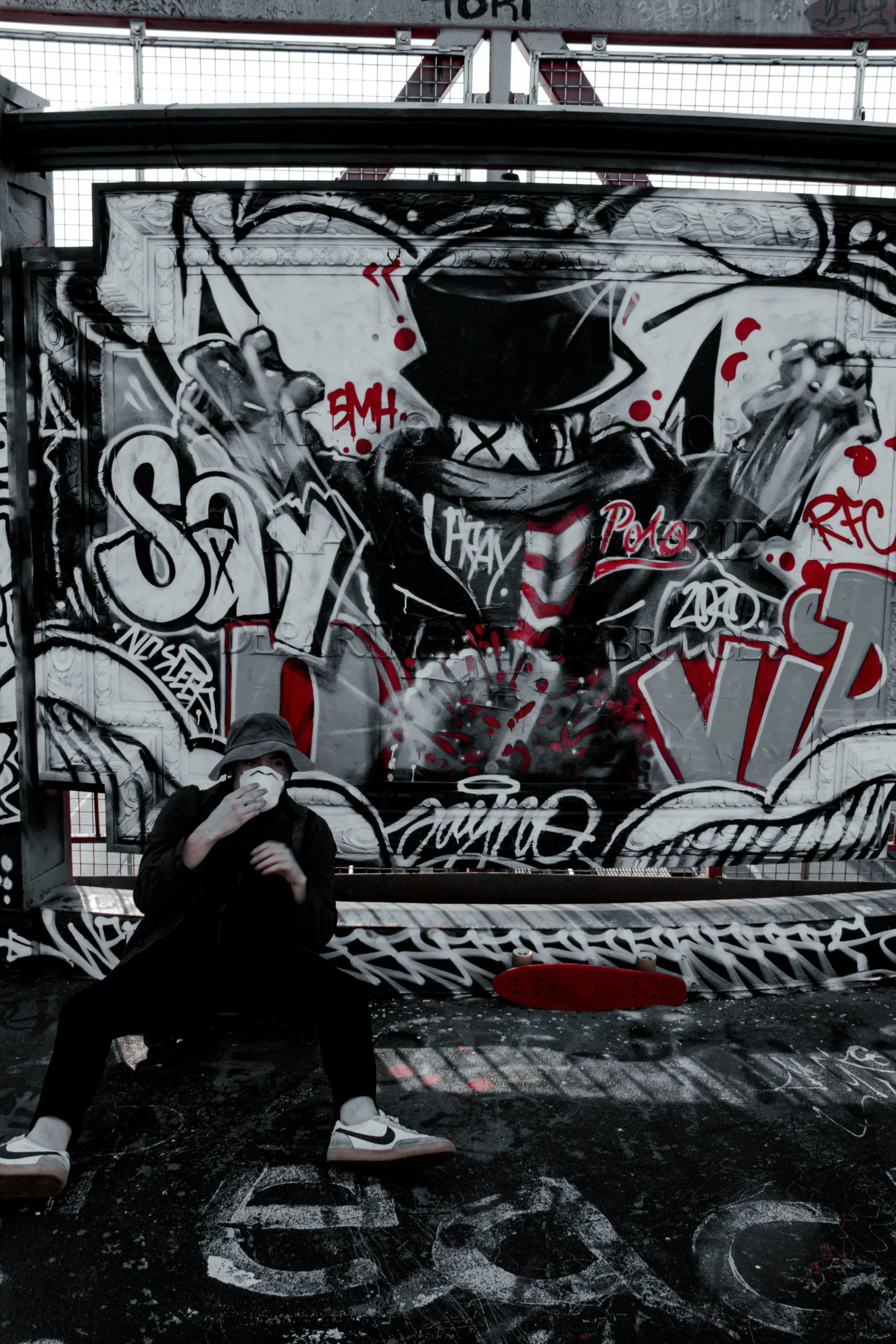 a woman with her back to the camera sitting against the side of a wall