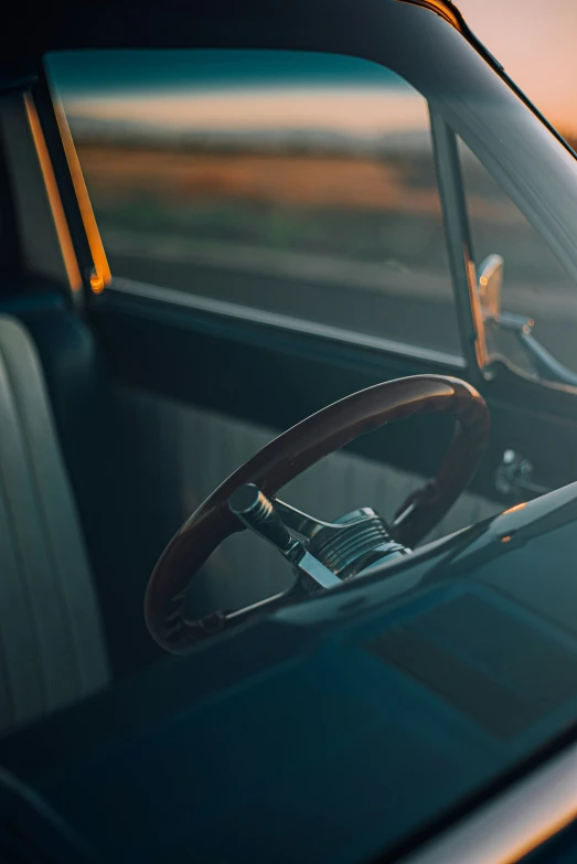 a vehicle interior that is dark with the sun setting on it