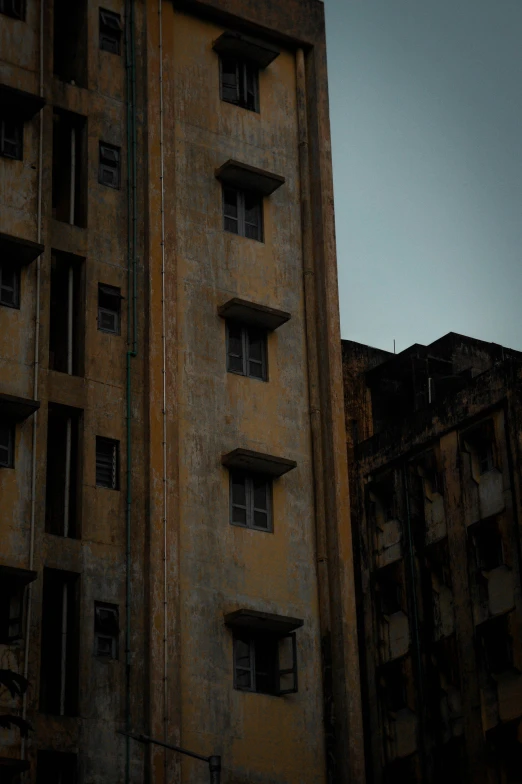 a tall building with three windows and no curtains