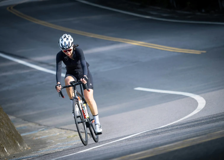 a person riding a bike down a curvy street