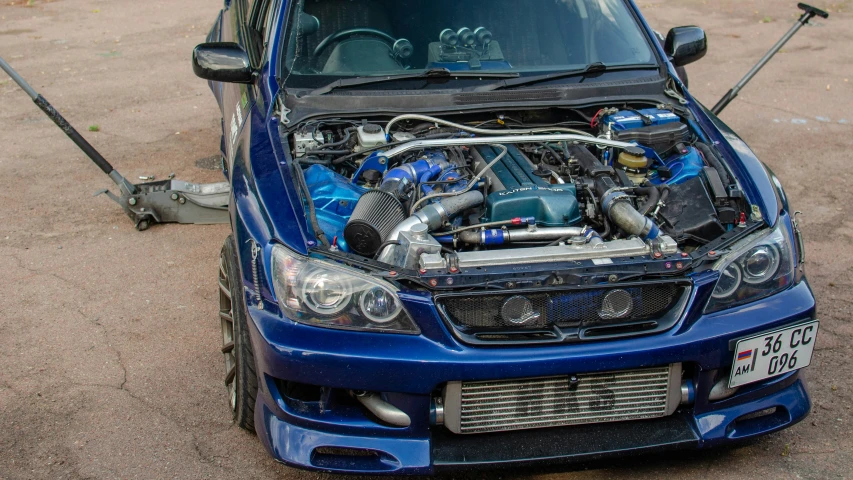 the front of a blue car with its hood open