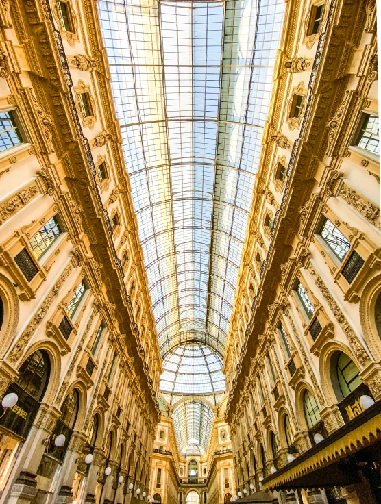 the interior of a large building with a big glass ceiling