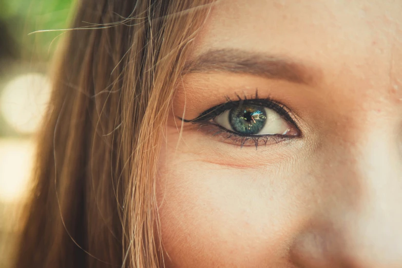 a beautiful young woman's blue eyes with long eyelashes