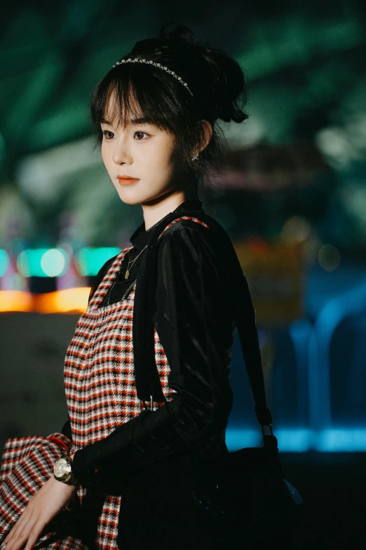 a young woman poses for a po in the dark