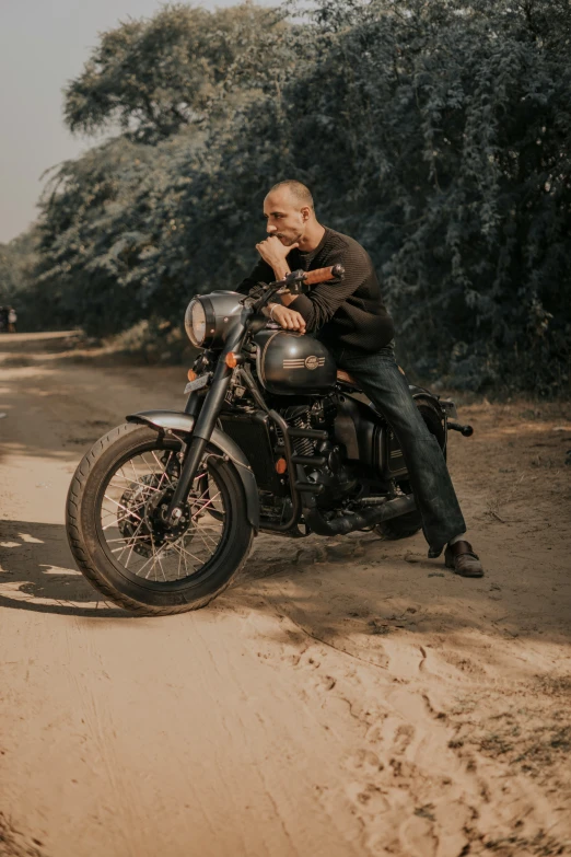 a man on a motorcycle on dirt road