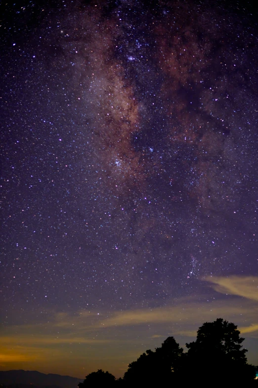 many stars with purple background and one cloud