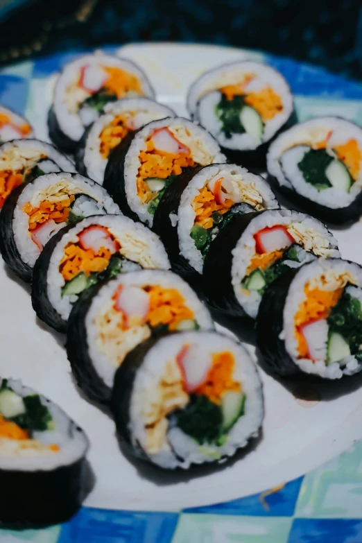 a plate with sushi on it with sauces