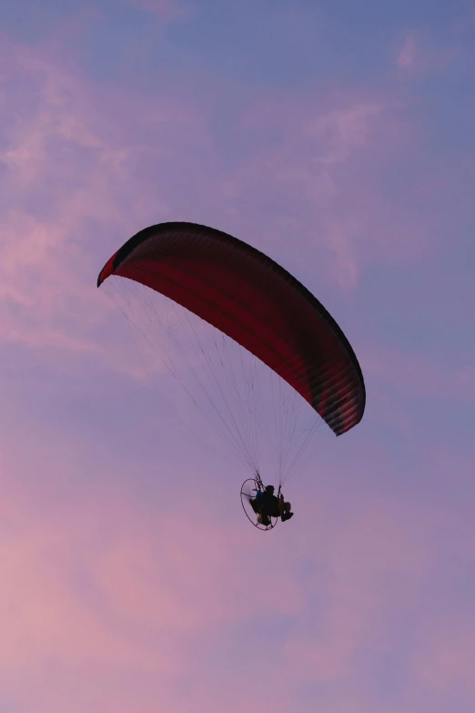 an aerial po of a man paragliding