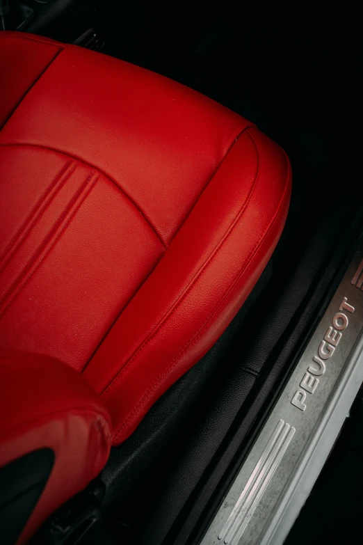 a red seat sits on the side of a vehicle