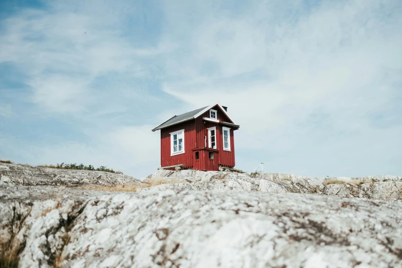 a small cabin sitting on top of a hill