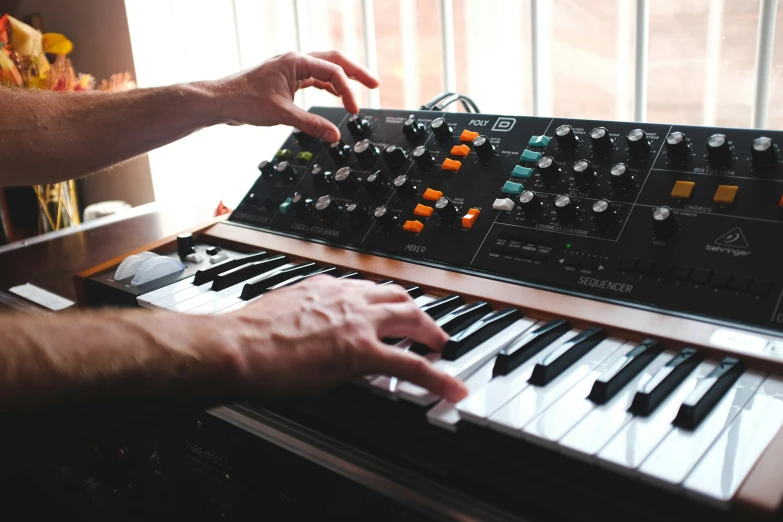 the hands of a man are hing keys on an electric organ