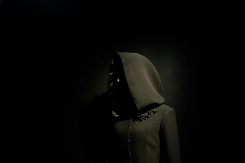 a hood on a mannequin wearing a black coat