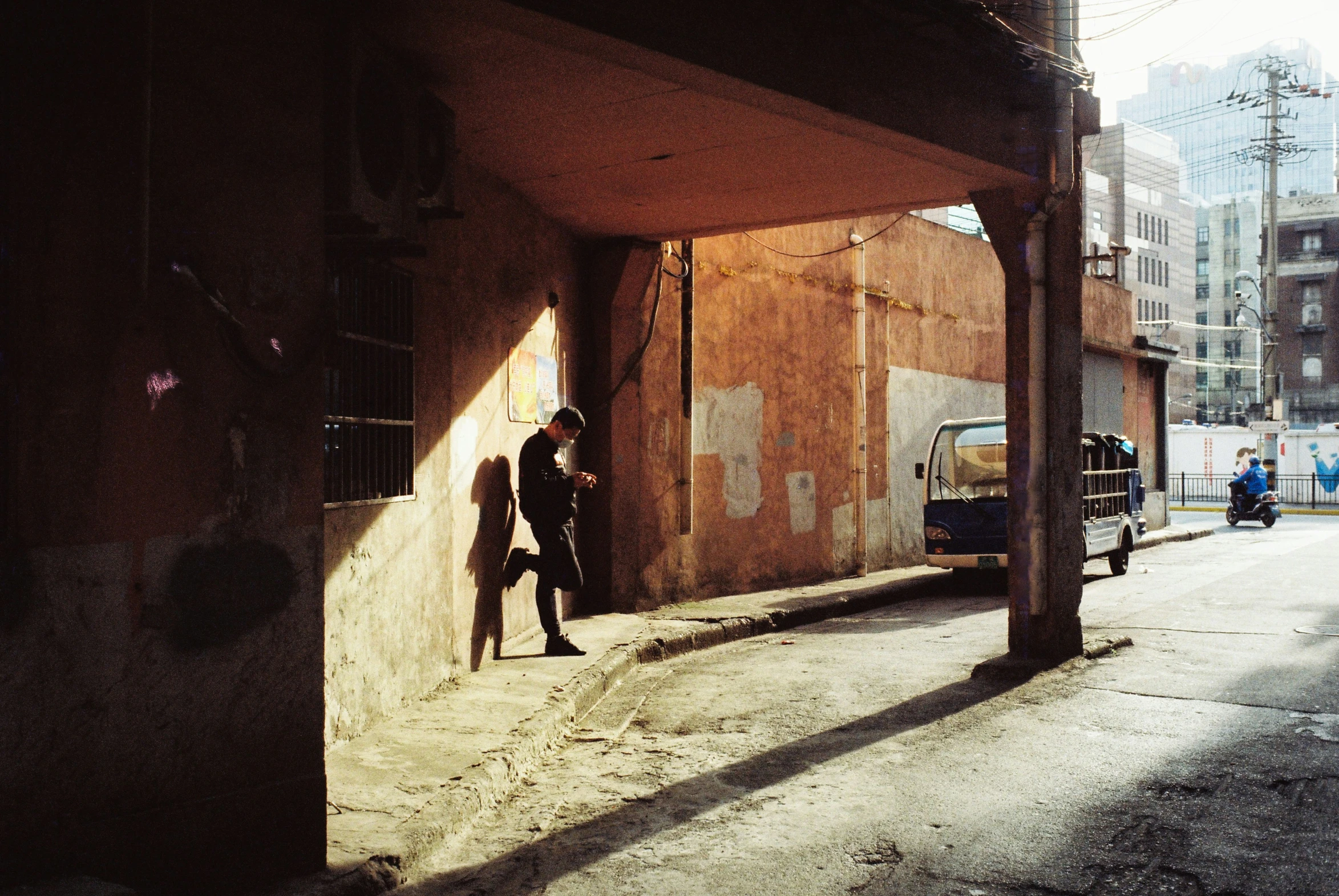 two men walking down an alleyway in the city
