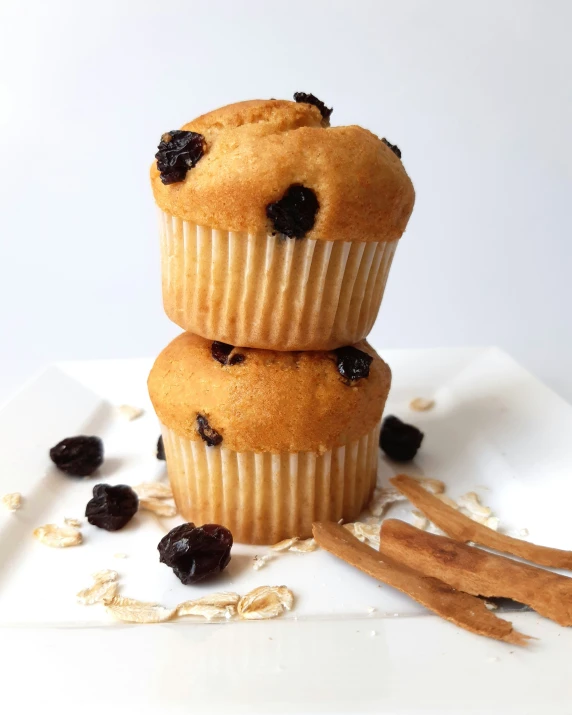 a white plate topped with a couple of muffins