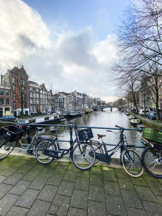 bicycles are parked along a canal in europe