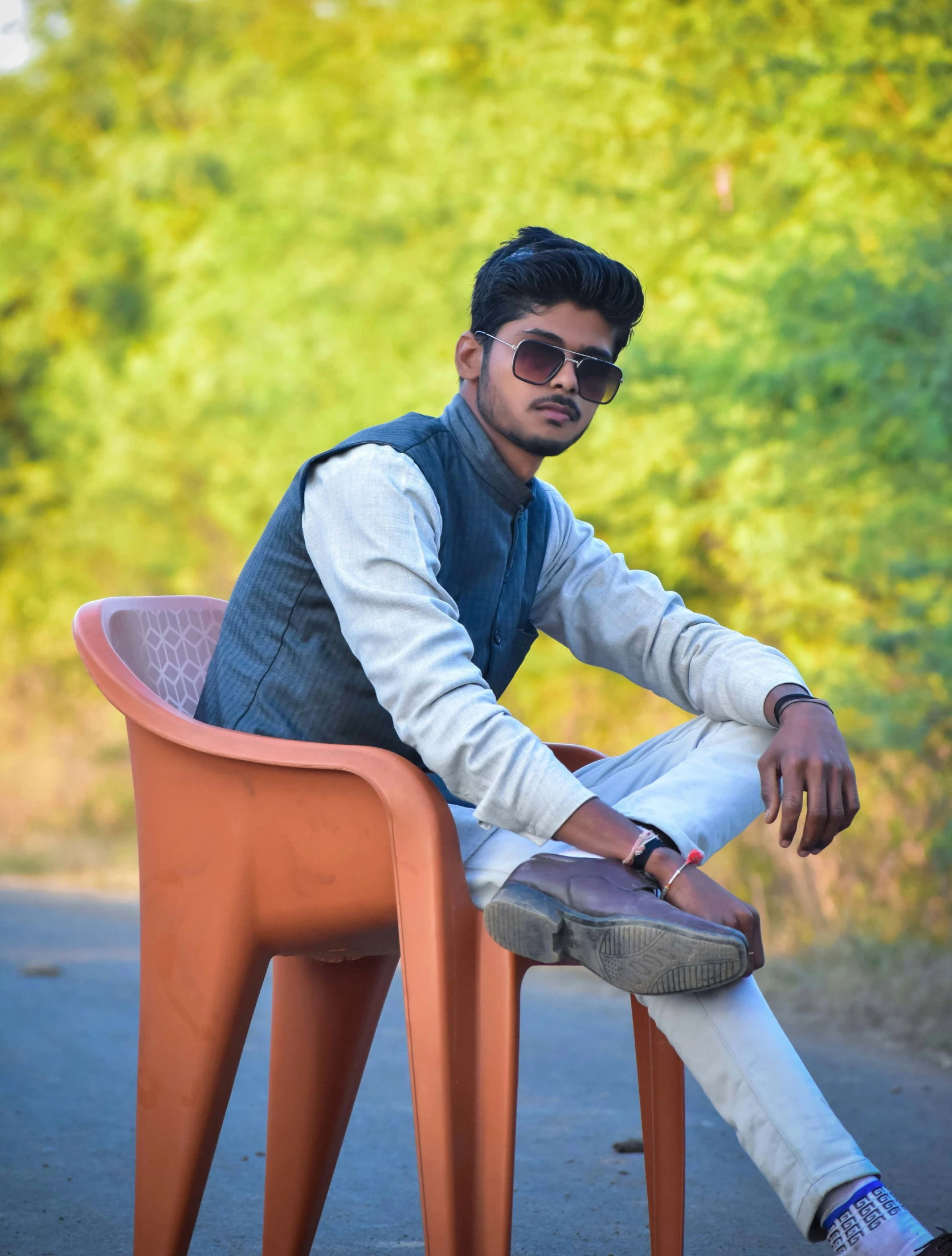 a man sitting on top of a plastic chair